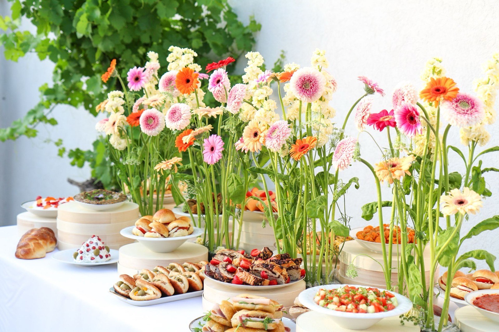 Buffet fait maison Entre L à Aix-en-Provence habillé de gerberas : hallah, fricassés, babka aux fraises et salade de légumes